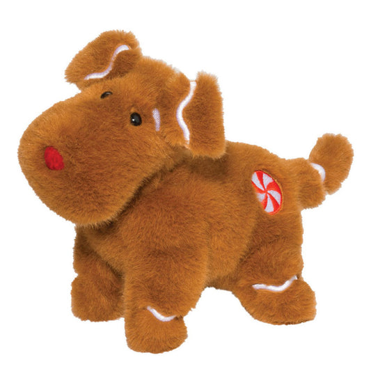 Det här är en pepparkakshund från Douglas Cuddle Toys. Liten hund som står på fyra ben, med tät, kort till mellanlång och något rufsig päls med mjuk glans. Pälsen är brun med vita detaljer på öronens insida, öronkanterna, svansringen och böjda märken ovanför tassarna. Nos, mage och tassar är bruna. Ögonen är svarta och sitter tätt ihop, nosen är röd och rund. På höger sida sitter en broderad rund fläck i rött och vitt som en pepparmyntskaramell. Uttrycket är milt och nyfiket.