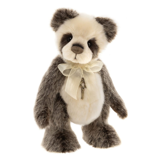 Det här är Ticklish, en nalle i plysch från Charlie Bears. Pälsen är lång och lätt rufsig med svag glans, kortare på huvud och mage, längre och fluffigare på armar, ben och öron. Pannan och magen är vita, öron, armar och ben grå, och ögonfläckarna mörkbruna. Nospartiet är krämvitt och runt, öronens insida och tassarnas ovansida grå, trampdynorna mörkbruna, nosen brun och ögonen svarta. Han sitter, bär en beige rosett och ett litet nyckelhalsband och ser mild och nyfiken ut.