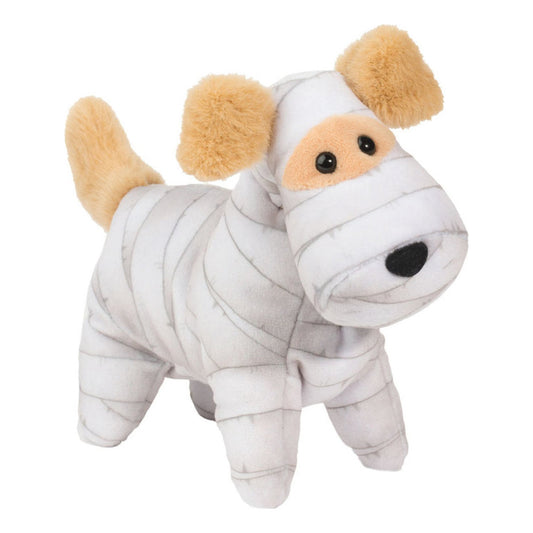 Det här är en mumiehund från Douglas Cuddle Toys. Liten hund i stående pose med kort, slät och tät plyschpäls som har en svag glans. Grundpälsen är vit med grå bandageliknande ränder runt huvud, kropp och ben. Öronen, svansen och nosfläcken kring ögonen är beige och har samma korta, fluffiga struktur som resten av pälsen. Magen och tassarna är vita med grå ränder. Ögonen är svarta och runda, nosen svart och oval. Uppsynen är vänlig och nyfiken.